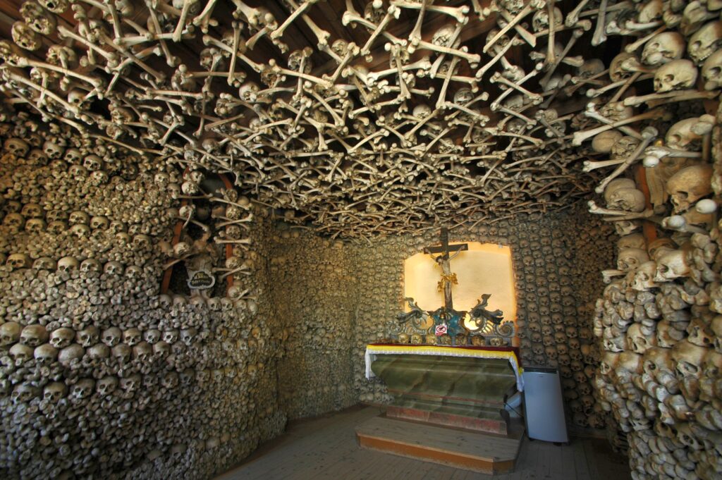 The altar of the Chapel in Czermna, Poland, adorned with bones and skulls arranged in intricate patterns and designs.